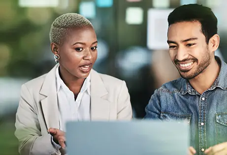 Man and woman in front of a computer screen